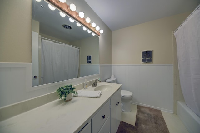 906 Carlee Dr, Brenham, TX 77833 - bathroom featuring vanity, toilet, wainscoting, and shower / bathtub combination with curtain
