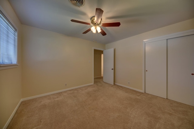906 Carlee Dr, Brenham, TX 77833 - unfurnished bedroom featuring light colored carpet, baseboards, a closet, and a ceiling fan