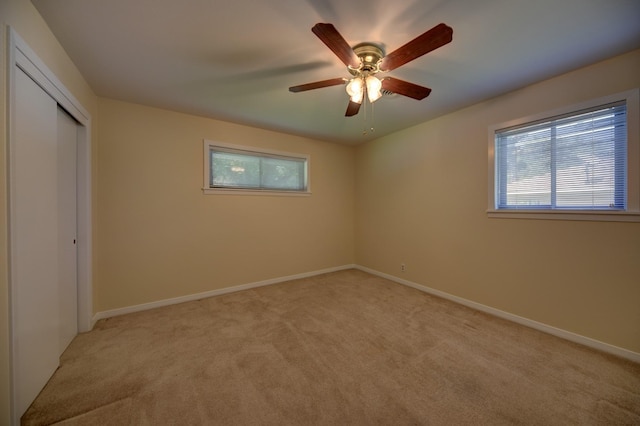 906 Carlee Dr, Brenham, TX 77833 - unfurnished bedroom with light colored carpet, a closet, baseboards, and ceiling fan