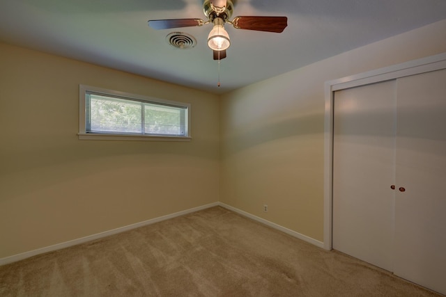 906 Carlee Dr, Brenham, TX 77833 - unfurnished bedroom featuring light colored carpet, a closet, baseboards, and ceiling fan