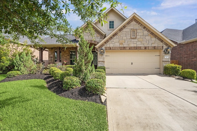 19726 Terrace Cliff Ct, Richmond, TX 77407 - view of front of home featuring stone siding, driveway, a garage, a front lawn, and stucco siding