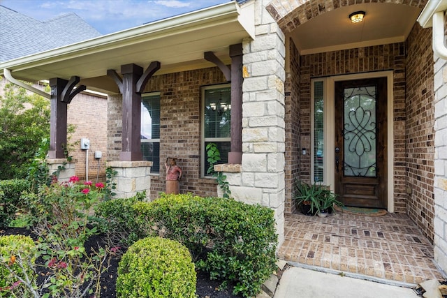 19726 Terrace Cliff Ct, Richmond, TX 77407 - view of exterior entry with covered porch, brick siding, and stone siding