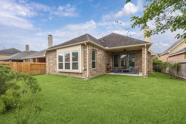 19726 Terrace Cliff Ct, Richmond, TX 77407 - rear view of property featuring a ceiling fan, a chimney, brick siding, and a patio area