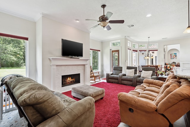 19 Shields Ln, Montgomery, TX 77356 - living area featuring crown molding, a tile fireplace, ceiling fan, plenty of natural light, and a chandelier