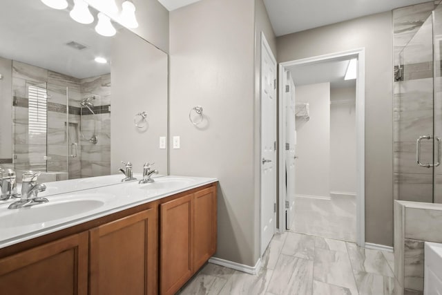 4522 Woodspring Glen Ln, Houston, TX 77345 - bathroom with a shower stall, a walk in closet, double vanity, marble finish flooring, and baseboards