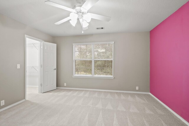 4522 Woodspring Glen Ln, Houston, TX 77345 - unfurnished bedroom featuring carpet floors, a walk in closet, a ceiling fan, and baseboards