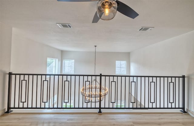 6 Rio Seco Dr, Uvalde, TX 78801 - hall with a chandelier, plenty of natural light, wood finished floors, and a textured ceiling