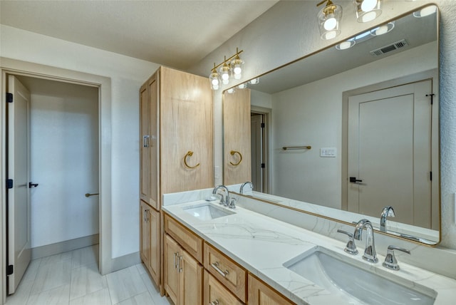 6 Rio Seco Dr, Uvalde, TX 78801 - bathroom with double vanity and baseboards