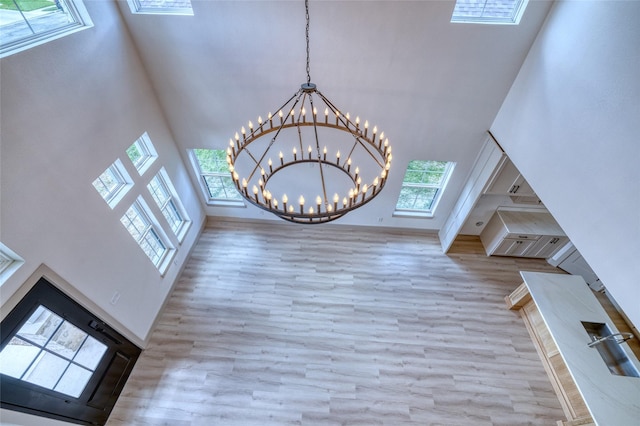 6 Rio Seco Dr, Uvalde, TX 78801 - staircase with a towering ceiling, wood finished floors, and a chandelier