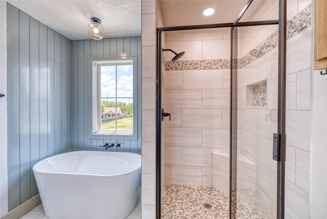 6 Rio Seco Dr, Uvalde, TX 78801 - full bathroom with a freestanding tub, a shower stall, a textured ceiling, and recessed lighting