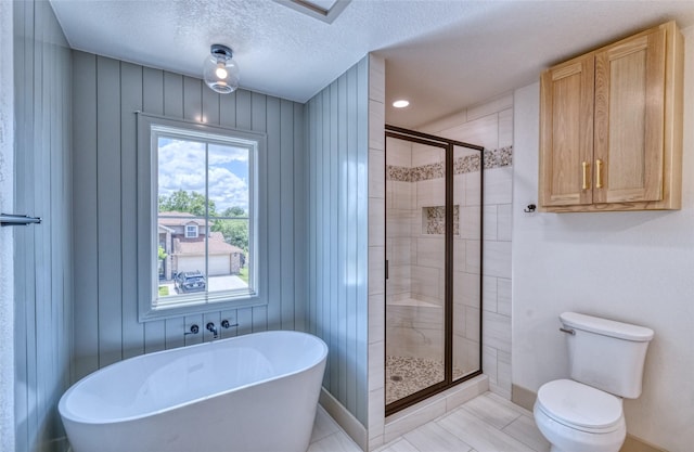 6 Rio Seco Dr, Uvalde, TX 78801 - full bath featuring a freestanding tub, a stall shower, a textured ceiling, and tile patterned flooring