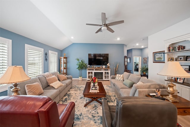 4236 Waterlily Spring Way, Porter, TX 77365 - living room featuring ceiling fan, healthy amount of natural light, wood finished floors, lofted ceiling, and a fireplace
