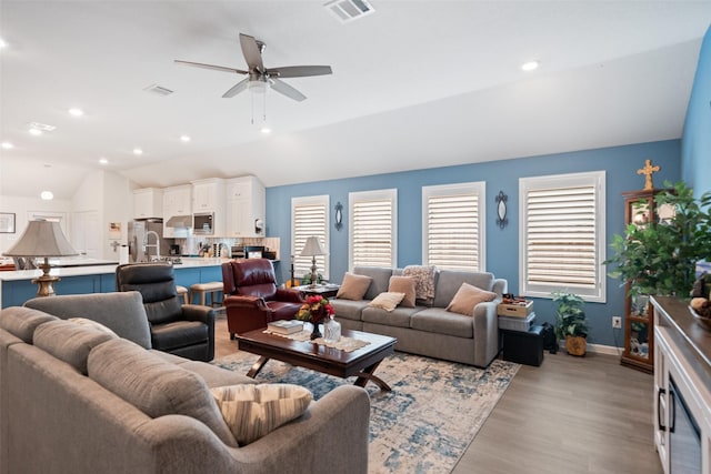 4236 Waterlily Spring Way, Porter, TX 77365 - living area featuring lofted ceiling, light wood finished floors, ceiling fan, baseboards, and recessed lighting