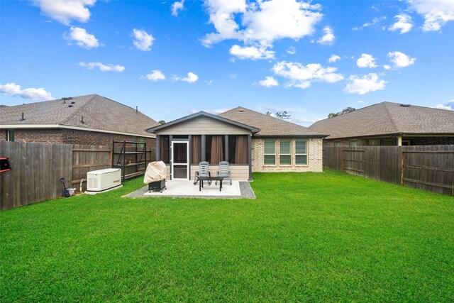 4236 Waterlily Spring Way, Porter, TX 77365 - back of property featuring a sunroom, a patio, brick siding, and roof with shingles