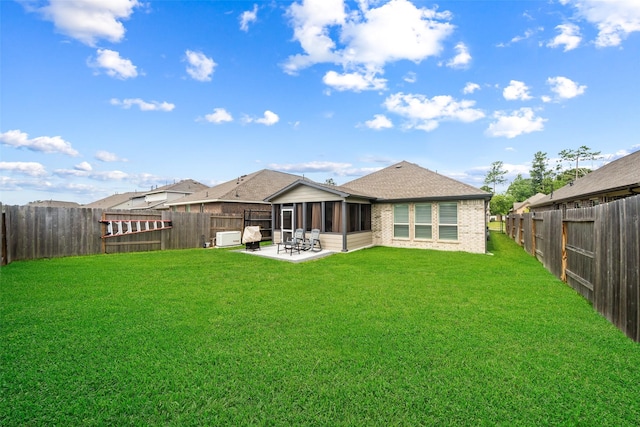 4236 Waterlily Spring Way, Porter, TX 77365 - rear view of house featuring a sunroom, a patio area, brick siding, and roof with shingles