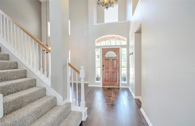 19927 Maple Village Dr, Cypress, TX 77433 - foyer featuring stairway, dark wood-style floors, baseboards, a chandelier, and a towering ceiling