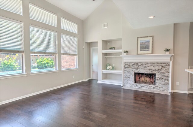 19927 Maple Village Dr, Cypress, TX 77433 - unfurnished living room with built in features, high vaulted ceiling, dark wood-type flooring, baseboards, and a fireplace with flush hearth