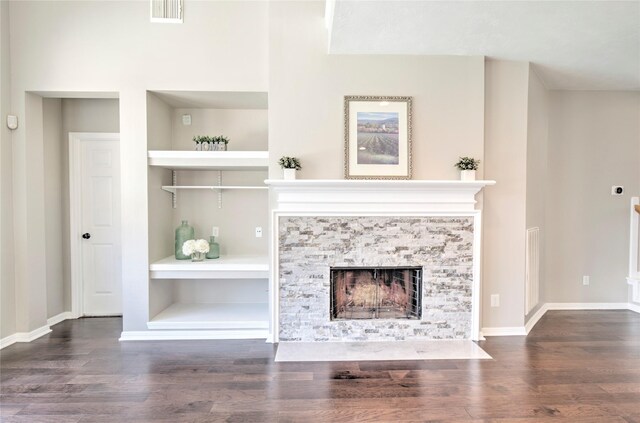 19927 Maple Village Dr, Cypress, TX 77433 - unfurnished living room featuring wood finished floors, a stone fireplace, built in shelves, and baseboards