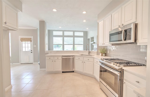 19927 Maple Village Dr, Cypress, TX 77433 - kitchen with appliances with stainless steel finishes, a sink, backsplash, light countertops, and recessed lighting