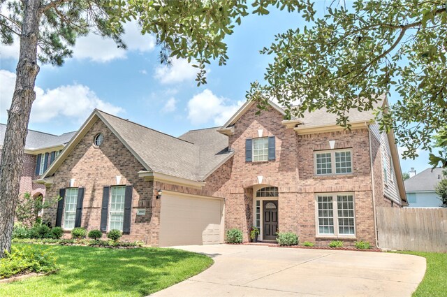 19927 Maple Village Dr, Cypress, TX 77433 - view of front of house featuring brick siding, driveway, a shingled roof, and an attached garage