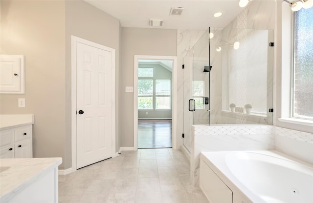 19927 Maple Village Dr, Cypress, TX 77433 - full bath with a marble finish shower, a bath, vanity, baseboards, and tile patterned floors