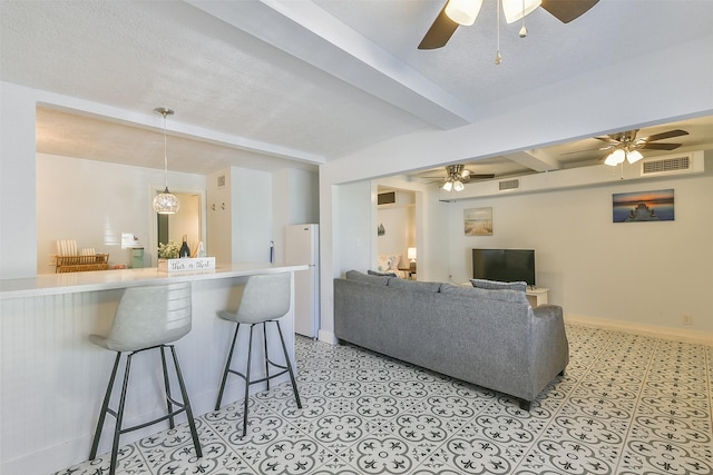 1513 19th St, Galveston, TX 77550 - living area featuring ceiling fan, beam ceiling, and baseboards