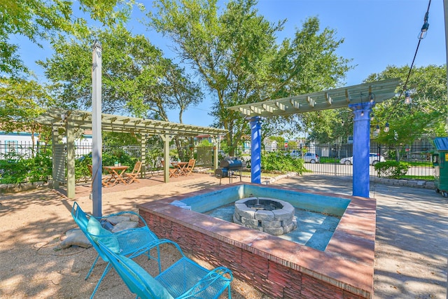 1513 19th St, Galveston, TX 77550 - view of playground featuring a pergola, a fire pit, and a patio area
