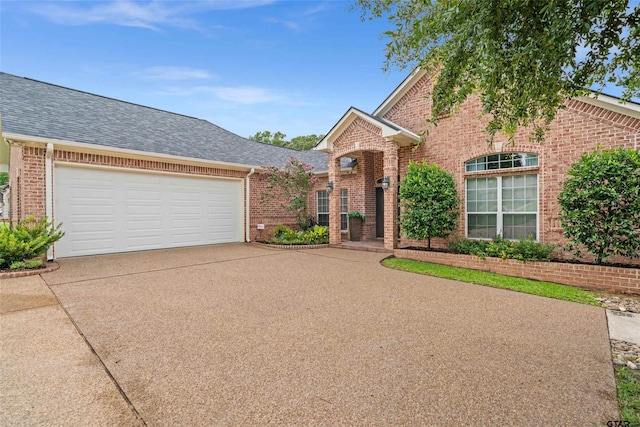 420 Bunker Dr, Tyler, TX 75703 - traditional-style home featuring brick siding, concrete driveway, roof with shingles, and an attached garage