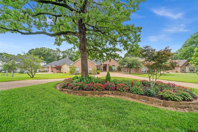 420 Bunker Dr, Tyler, TX 75703 - view of front of house with a front yard, curved driveway, and a residential view
