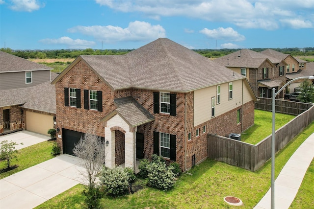 6531 Cody Mountain Trl, Richmond, TX 77407 - traditional-style home with brick siding, driveway, a garage, roof with shingles, and a residential view