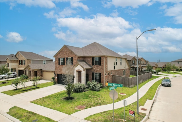 6531 Cody Mountain Trl, Richmond, TX 77407 - view of front of house featuring brick siding, a residential view, concrete driveway, and a garage