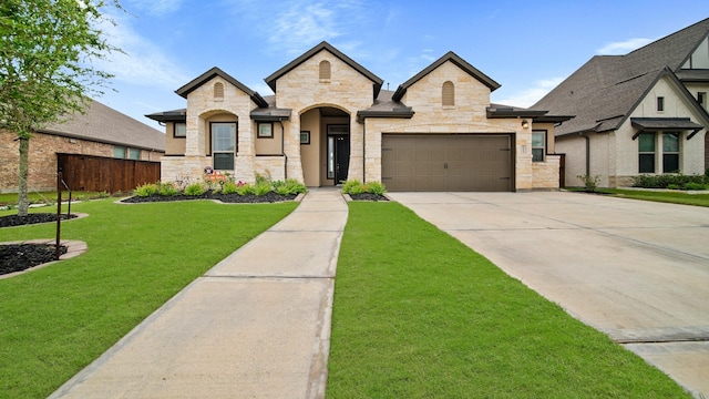 5903 Red River Dr, Manvel, TX 77578 - french provincial home with driveway, stone siding, and an attached garage