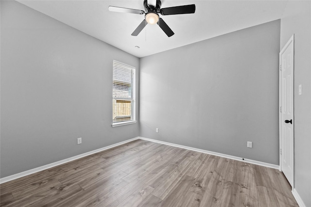 10506 Star Thistle Ct, Cypress, TX 77433 - spare room with wood finished floors, ceiling fan, and baseboards