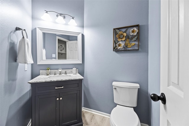 10506 Star Thistle Ct, Cypress, TX 77433 - bathroom featuring vanity, toilet, baseboards, and wood finished floors