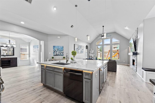 10506 Star Thistle Ct, Cypress, TX 77433 - kitchen featuring black dishwasher, open floor plan, gray cabinetry, arched walkways, and lofted ceiling