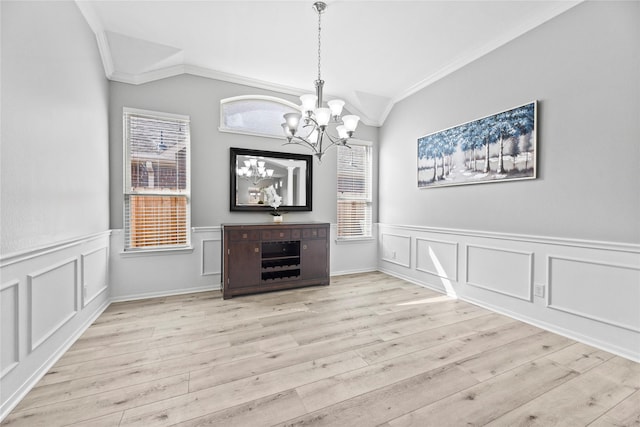 10506 Star Thistle Ct, Cypress, TX 77433 - unfurnished dining area with ornamental molding, a chandelier, wood finished floors, a wainscoted wall, and a decorative wall
