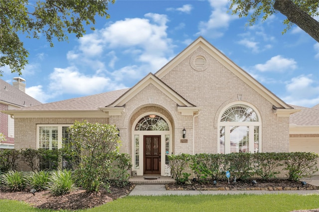 2005 Mistwood Ct, Pearland, TX 77584 - view of front of home featuring brick siding, roof with shingles, and a garage