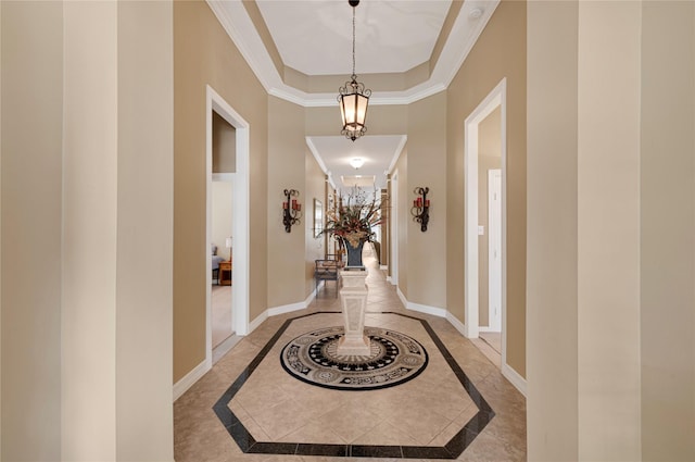 2005 Mistwood Ct, Pearland, TX 77584 - corridor with inlaid floor details, baseboards, crown molding, a chandelier, and a tray ceiling