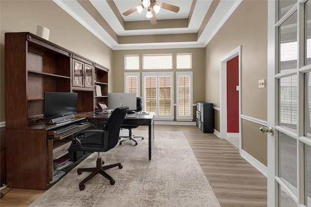 2005 Mistwood Ct, Pearland, TX 77584 - office space featuring a ceiling fan, light wood-style floors, crown molding, a tray ceiling, and baseboards