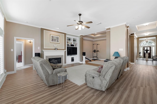 2005 Mistwood Ct, Pearland, TX 77584 - living area featuring baseboards, light wood-style floors, a glass covered fireplace, ornamental molding, and a ceiling fan