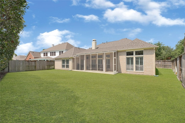 2005 Mistwood Ct, Pearland, TX 77584 - rear view of house with a sunroom, a chimney, a shingled roof, and brick siding