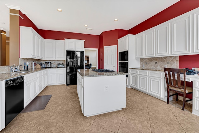 2005 Mistwood Ct, Pearland, TX 77584 - kitchen with black appliances, backsplash, a sink, white cabinets, and a center island
