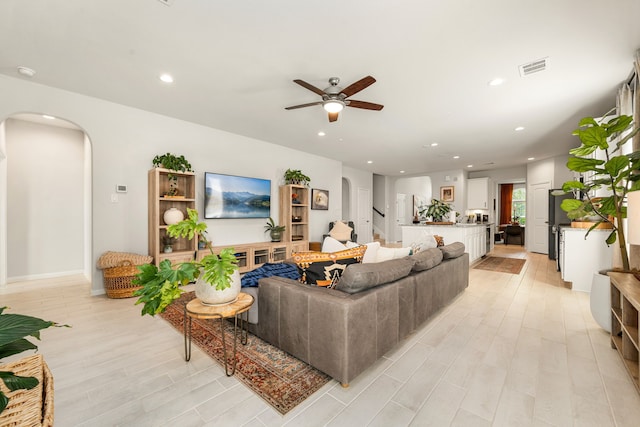 77 Indian Wells Dr, Manvel, TX 77578 - living room featuring arched walkways, ceiling fan, recessed lighting, and light wood finished floors