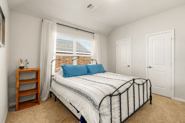 77 Indian Wells Dr, Manvel, TX 77578 - bedroom featuring light colored carpet, lofted ceiling, and baseboards