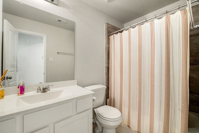 77 Indian Wells Dr, Manvel, TX 77578 - bathroom featuring vanity, toilet, a shower with shower curtain, and a textured ceiling