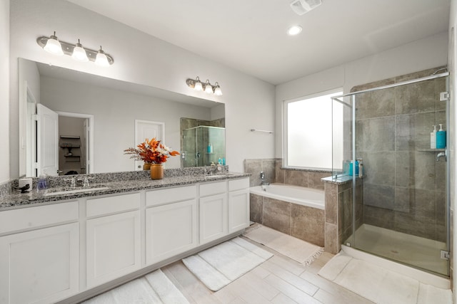 77 Indian Wells Dr, Manvel, TX 77578 - bathroom featuring a shower stall, double vanity, a garden tub, and recessed lighting