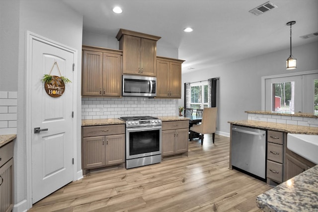 4142 Longhorn Dr, Cleveland, TX 77328 - kitchen with appliances with stainless steel finishes, tasteful backsplash, light wood finished floors, and recessed lighting