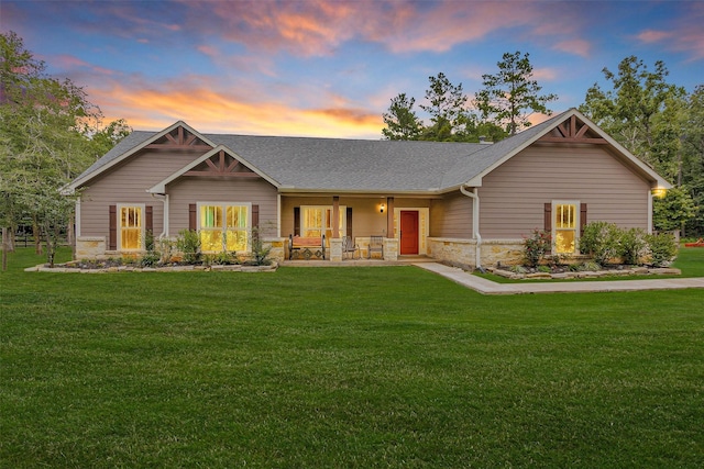 4142 Longhorn Dr, Cleveland, TX 77328 - craftsman-style house featuring stone siding, covered porch, a front lawn, and a shingled roof