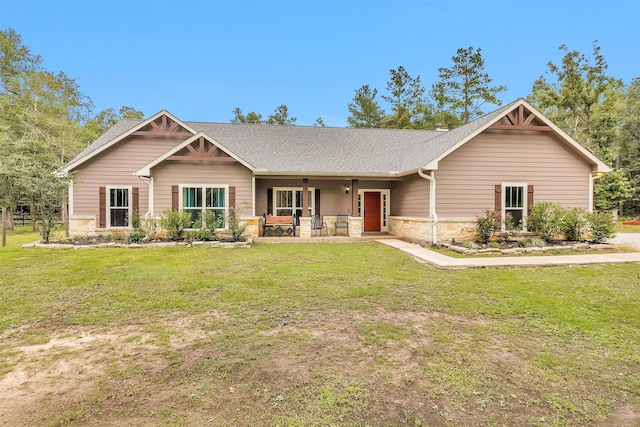 4142 Longhorn Dr, Cleveland, TX 77328 - craftsman-style home with a front yard, stone siding, a porch, and a shingled roof