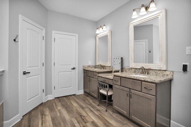 4142 Longhorn Dr, Cleveland, TX 77328 - bathroom with wood finished floors and two vanities